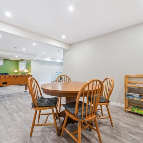 Spacious recreation level with board games and a round table for cards or family fun after a day of lake adventures.