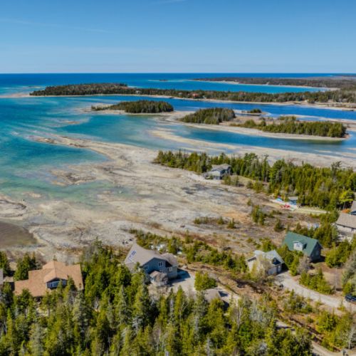 A stunning aerial view of a tranquil lakeside community along the Bruce Peninsula—perfect for a relaxing getaway, nature escape, or waterfront vacation.