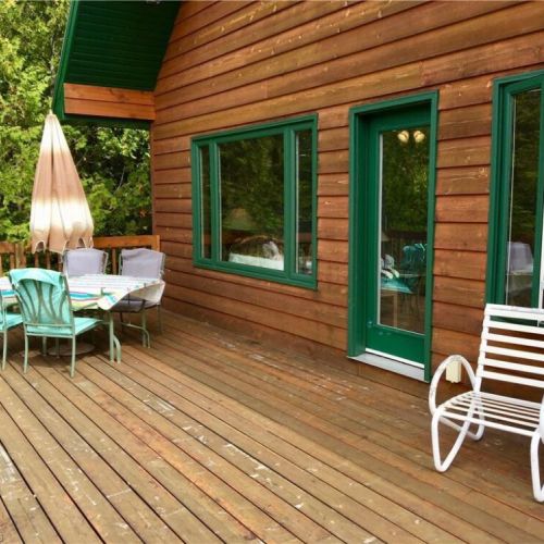 The spacious deck is ideal for outdoor dining, morning coffee, and evening sunsets through the trees.