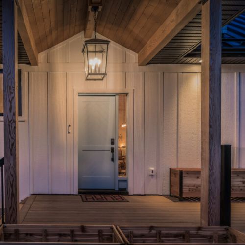 Welcoming cottage entry with warm lighting and stylish modern cabin vibes. A peaceful vacation rental retreat perfect for stargazing nights and nature-filled adventures.