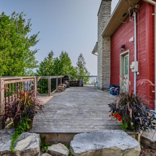 Step out onto the expansive deck and immerse yourself in the tranquil atmosphere. Whether you're enjoying a meal or simply soaking in the view, this space is perfect for outdoor living.