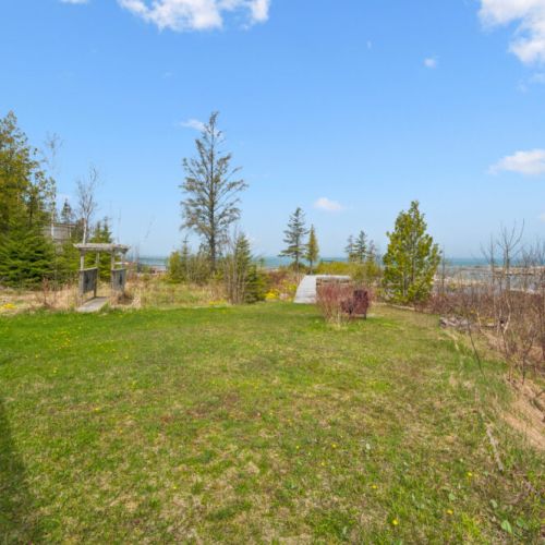 Large grassy yard overlooking the bay, ideal for family games and outdoor gatherings.