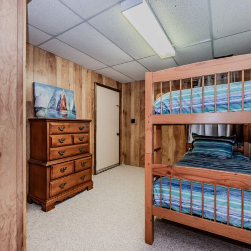Charming bunk room with vibrant bedding, a fun and comfortable space for kids during a lakeside family vacation.