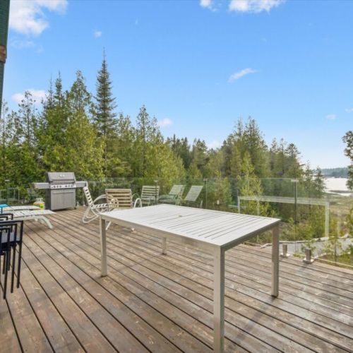 The expansive upper deck is ideal for outdoor dining, lounging, and sunset evenings.