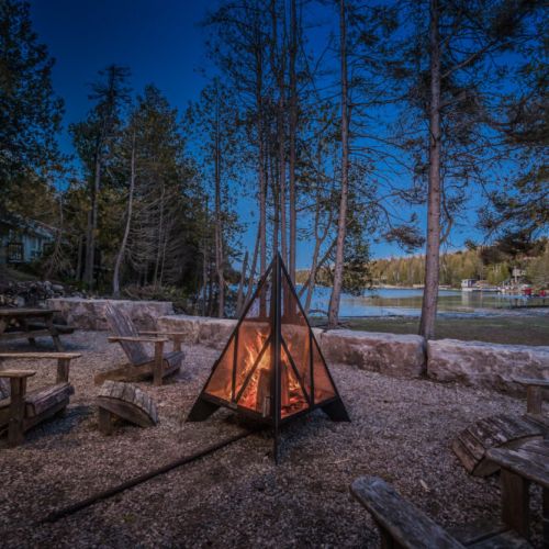 Unwind by the fire pit under the stars at this serene lakeside vacation rental—perfect for cozy evenings, nature escapes, and memorable moments in Ontario cottage country.