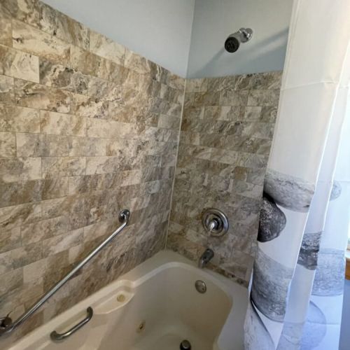 Full bathroom with tub and shower for relaxing after a day outside