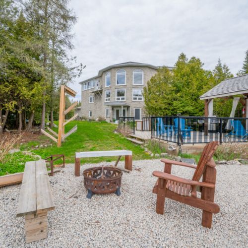 The firepit along the water is perfect for enjoying a cozy summer night.