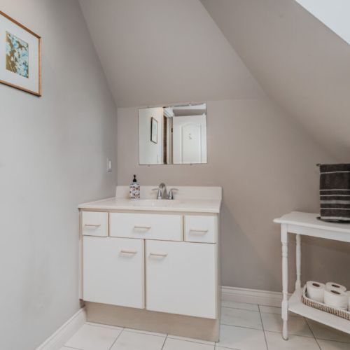 This upstairs bathroom is bright and spacious with a skylight, offering natural light for your morning routine.