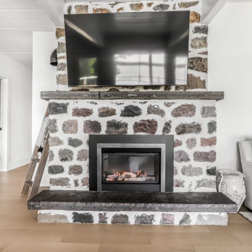 Gather around the stunning stone fireplace for warm evenings after a day on the lake.