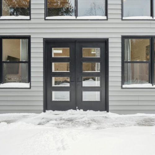 Modern exterior entrance with clean lines, contemporary doors, and easy year-round access.