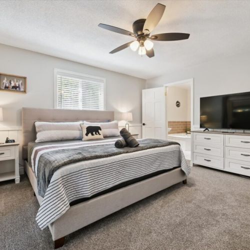 Inviting primary suite with a large TV, comfortable king bed, and plenty of space to unwind.