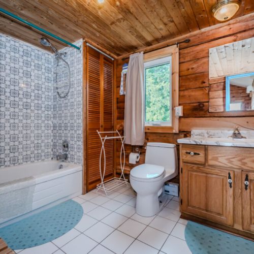 Experience the charm of this rustic bathroom, a perfect blend of woodsy appeal and modern convenience.