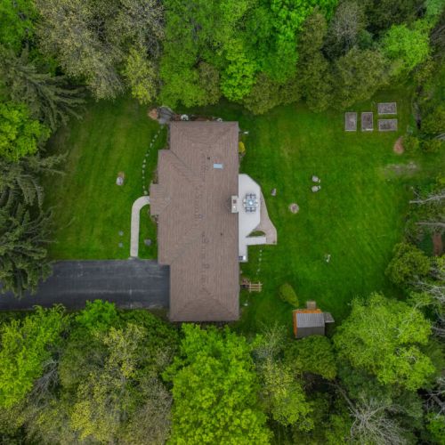 Full overhead view of the home, yard, and wooded surroundings—designed for guests craving privacy, tranquility, and connection to nature.