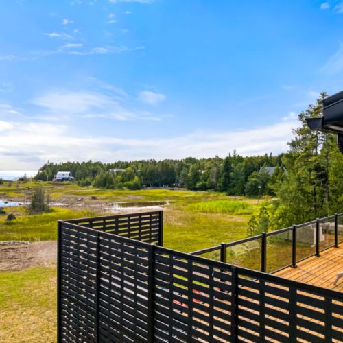 Privacy screens create a peaceful space to relax on the expansive deck.