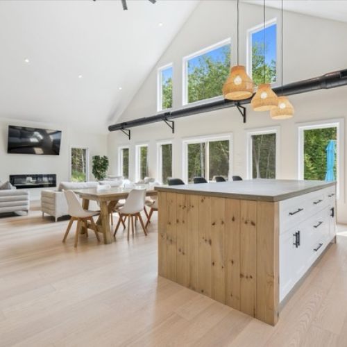 Dine together under soaring ceilings and natural light with a seamless flow between kitchen, dining, and living spaces.