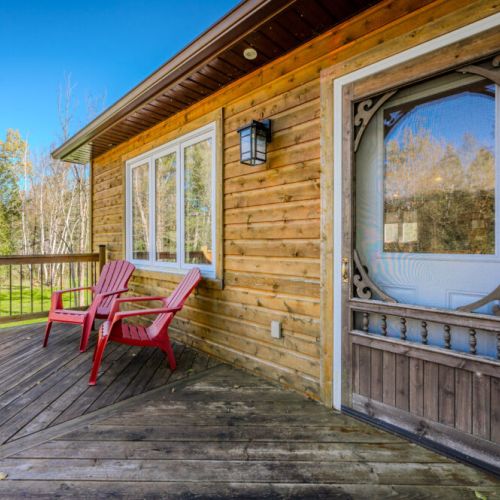 A peaceful front deck with seating, perfect for enjoying your morning coffee or relaxing in the fresh air.