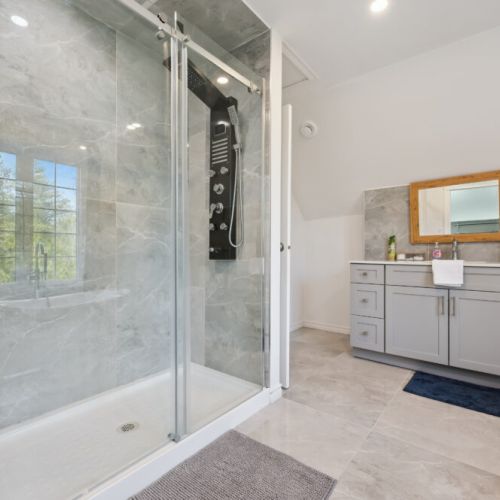 Walk-in glass shower with nearby walk-in closet for convenient storage