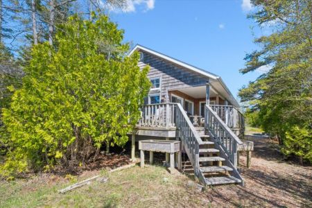 The elevated deck provides easy access to the cottage while creating the perfect spot to enjoy morning coffee, outdoor dining, or an evening under the stars.