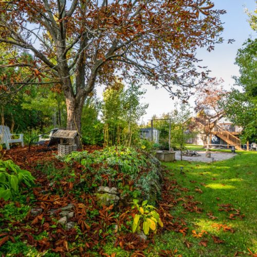 A serene pathway alongside the house, perfect for a quiet stroll or accessing the backyard.