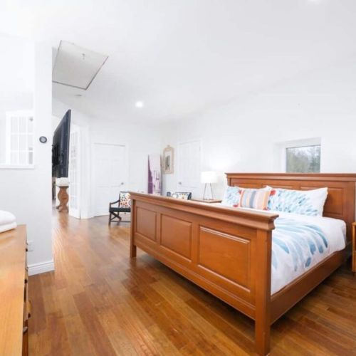 The Master bedroom, featuring a king-sized bed and private ensuite with independent tub and steam room.
