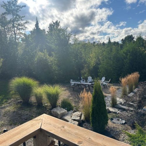 A peaceful outdoor gathering space surrounded by nature—perfect for fireside conversations and relaxing under the open sky.