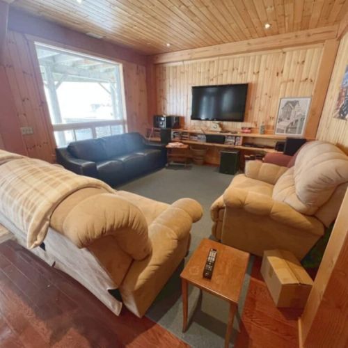 This additional living space on the lower level offers plush seating and a large TV, perfect for entertainment.