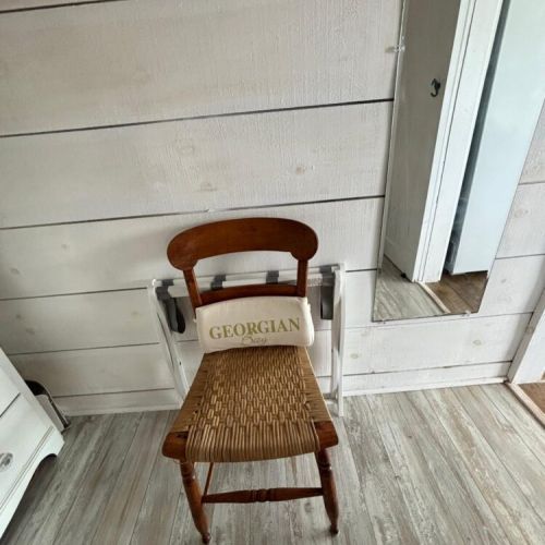 A cozy chair with a “Georgian” pillow, perfect for slipping off your shoes after a day outdoors.