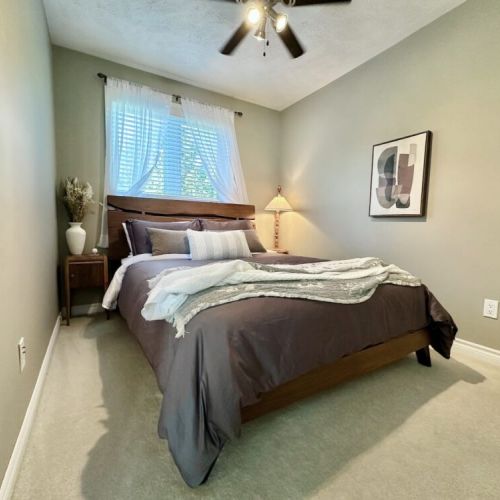 Comfortable queen bedroom with soft linens, ample storage, and easy access to the loft and nearby bathroom.