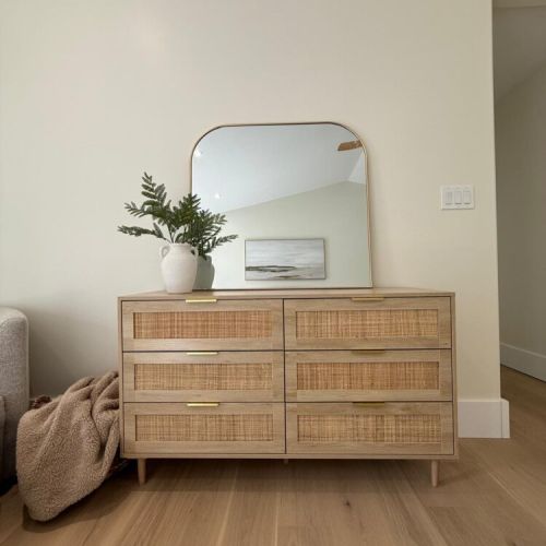 Thoughtful touches throughout—this rattan-accented dresser and curated design details create a tranquil atmosphere.