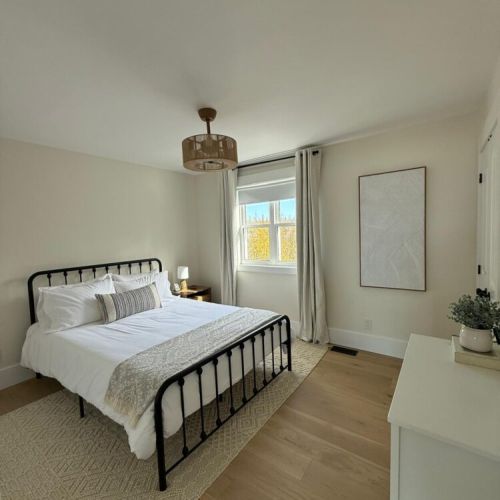 Unwind in a spacious queen suite with modern decor and natural textures for a boutique-hotel feel.