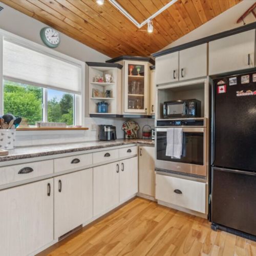 Spacious countertops and modern appliances make cooking here a breeze, with natural light streaming in through the window.