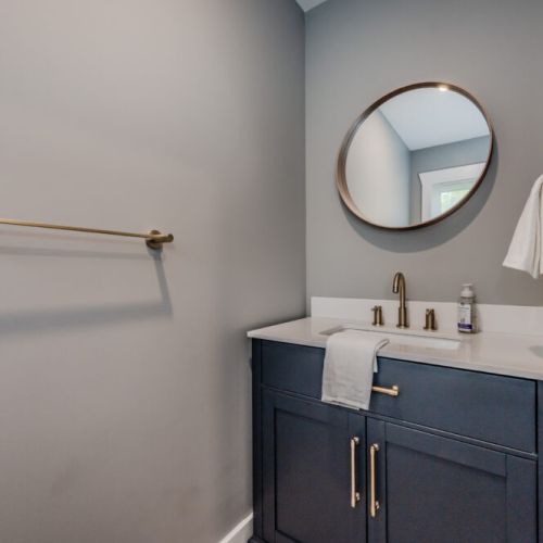 A stylish powder room with elegant fixtures, offering a convenient and private space for guests.