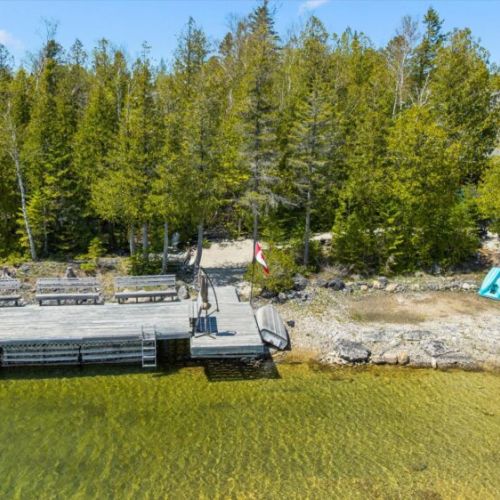 Enjoy direct waterfront access with a private dock and scenic shoreline setting perfect for summer days.