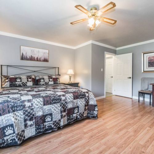 The Master bedroom features a dedicated work area, ensuite bathroom, and a treadmill. All linens and towels are supplied.