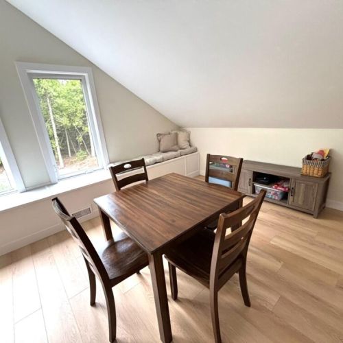 A perfect hideaway for quiet moments – enjoy board games, reading, or family fun in the cozy upstairs nook with forest-facing windows and a charming window seat.