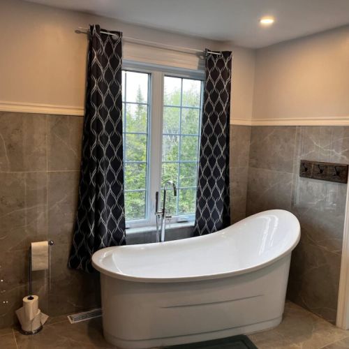 Spa-style bathroom with stand-alone soaker tub, perfect for relaxing after a day outdoors