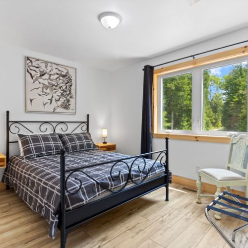 This inviting bedroom offers a quiet retreat surrounded by nature.