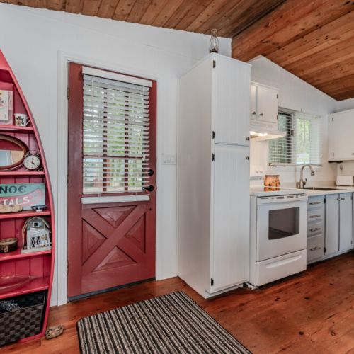 Cook up vacation meals in this full kitchen, featuring vintage charm, modern appliances, and fun lake-themed touches.