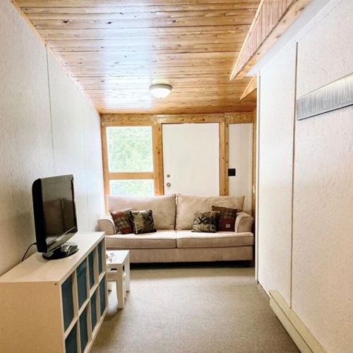 Snuggle into the comfy nook with a plush sofa, TV, and toys, the perfect play-space for kids.