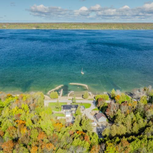 Expansive lakefront with a private dock, ideal for launching small watercraft or enjoying picturesque views.