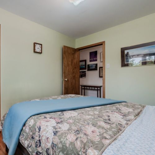 Comfortable second bedroom with soft lighting, storage space, and a peaceful atmosphere—perfect for a quiet night after exploring the Bruce Peninsula.