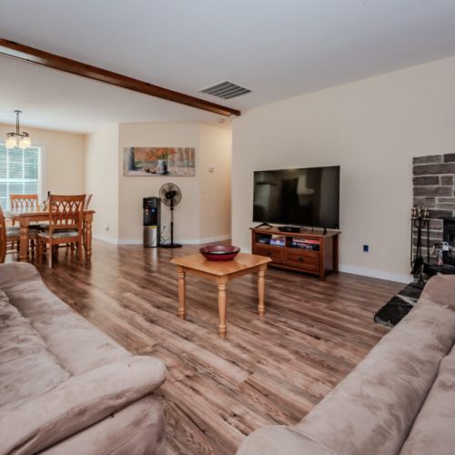 Relax in the comfortable living space, complete with plush seating, a smart TV, and a cozy fireplace, perfect for unwinding after a day of adventure.