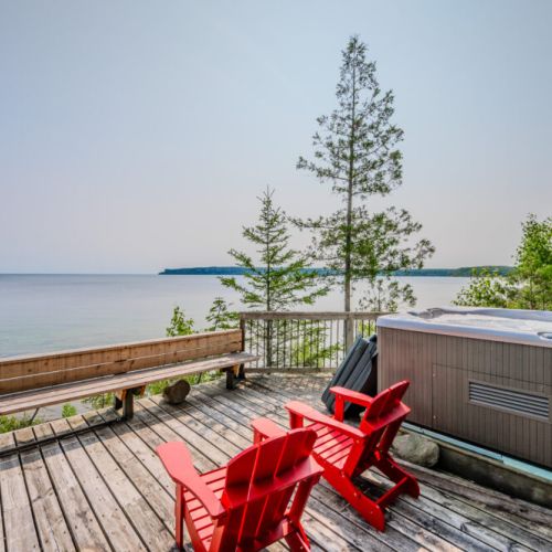 The hot tub area on the deck provides a peaceful retreat with unparalleled views of the water. It's perfect for a soothing soak after a day of exploring the peninsula.
