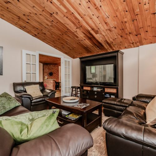 The vaulted ceilings and open living area create a warm, inviting space perfect for gathering with family and friends.