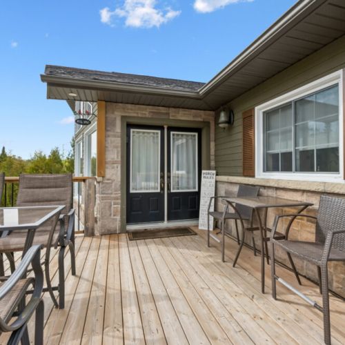 Additional outdoor seating at the front of the cottage offers a welcoming spot to gather, enjoy meals in the sunshine, or simply sit and relax while spending time together.