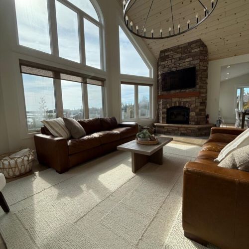 Soak in natural light and lake views from a soaring great room with vaulted ceilings and a cozy stone fireplace.