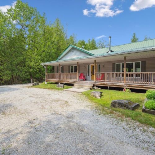 A welcoming front view of Pike & Pine, with ample parking and a wide porch to enjoy the fresh Bruce Peninsula air.