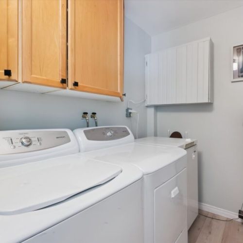 Convenient in-cottage laundry area with washer and dryer available for guest use during extended stays.