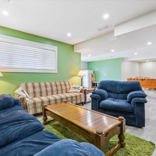 Comfortable lounge seating in the lower level — gather for movie nights, chats, or relaxation after swimming and exploring.