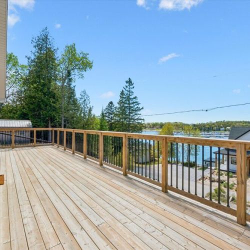 Enjoy panoramic views toward Georgian Bay from this generous outdoor living space perched above the village.